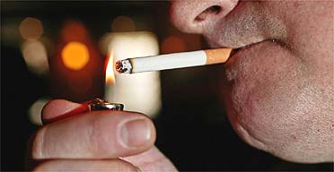 A man lights a cigarette in a pub in Nottingham