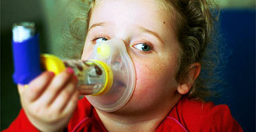 Four-year-old Georgia Conely inhaling steroids to treat her asthma. Photograph: Sean Smith/Guardian