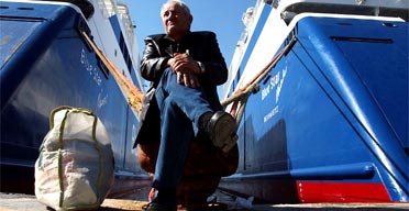 A passenger stranded at Piraeus harbour by the week-long ferry strike in the Greek islands