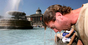 A man dunks his head in the Trafalgar Square fountain in central London as temperatures soar around the country. Photograph: Rebecca Reid/PA