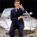 Actor Pierce Brosnan sits on an Aston Martin