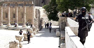 Jordanian police secure the area where foreign tourists were attacked by a gunman in Amman