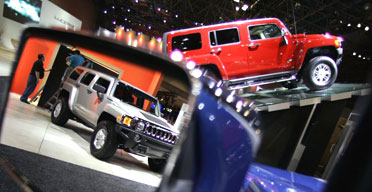 The latest Hummer, above, and the Toyota Prius hybrid