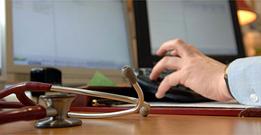 A doctor using his computer