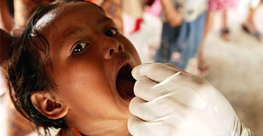 A boy receives vitamin A before a measles vaccination in Panga on Acehs west coast in the aftermath of the Indian Ocean tsunami