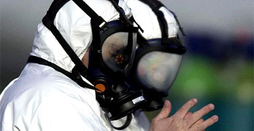 Workers wearing protective suits and breathing masks enter the Bernard Matthews turkey Farm at Holton in Suffolk