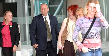 Dr Russell Reid leaves the GMC, accompanied by some of his transgender supporters, after being found guilty of serious professional misconduct. Photograph: Stefan Rousseau/PA