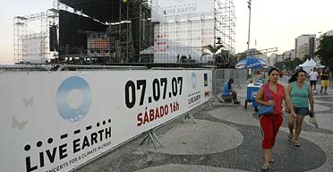 People walk past the stage where the Live Earth concert is due to be held