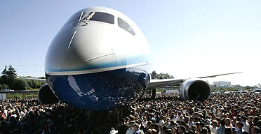 Visitors crowd around the first production model of the new Boeing 787 Dreamliner
