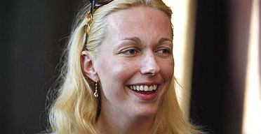 Katharina Wagner, the great-granddaughter of Richard Wagner, smiles during a break in the rehearsal of the opera Die Meistersinger von Nuernberg, which opens today at the Bayreuth festival