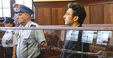 Author Krystian Bala listens as a court convicts him of directing the killing of a local businessman
