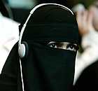 A veiled delegate listening to headphones at the Assembly for the Protection of Hijab (aka Pro-Hijab) at city hall, London. 