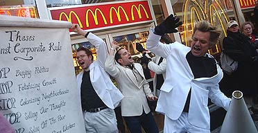 New York performance artist Bill Talen, aka Reverend Billy, holds a megaphone in front of McDonalds in Times Square.