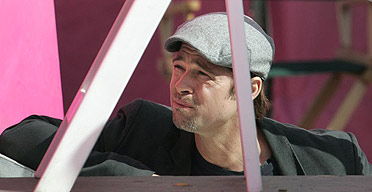 Actor Brad Pitt listens as residents of the Lower Ninth Ward tell their stories about Hurricane Katrina during a news conference in New Orleans.