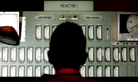A power station worker monitors one of the reactors in the control room of Oldbury nuclear power station