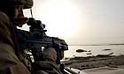 A British soldier patrols the northern suburbs of the southern Iraqi city of Basra