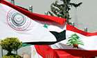The flags of Arab league, Syria and Lebanon are seen in front of the Ebla Conference hall in Damascus, where the Arab League summit will be held. Photograph: Bassem Tallawi/AP