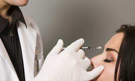 Dermatologist holding syringe during botox