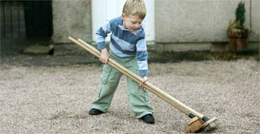 Samuel Houghton, 5, with his 'improved broom' invention
