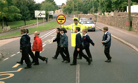 Lollipop woman sees children safely across a road