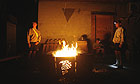US soldiers from Charlie Company, 173rd Brigade (Airborne), stand around a fire in Bermel, Paktika province, Afghanistan.
