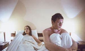 Unhappy couple in bed