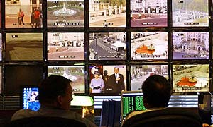 Police officers monitor CCTV screens in the control room at New Scotland Yard in London