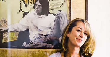 Alison Donald, managing director of chrysalis records, in front of a poster of Neil Young
