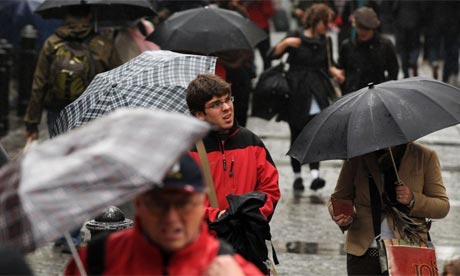 Crowds of shoppers walk with umbrellas in the rain in Covent Garden, London. Photo: Linda Nylind