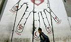 A Palestinian boy walks past a section of the barrier in the West Bank city of Bethlehem
