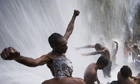 Voodoo and Catholic followers bathe in the waterfall at Saut Deau Haiti
