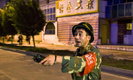 A member of the Chinese security services guards the site of the terrorist attack in Kashgar
