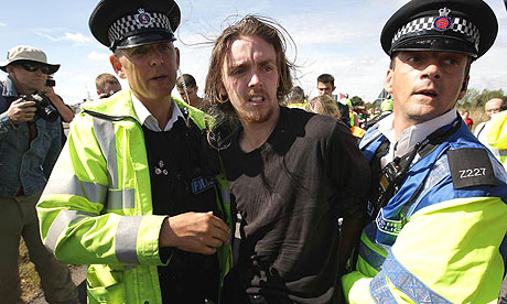 Police officers scuffle with climate change protesters near Kingsnorth power station in Kent