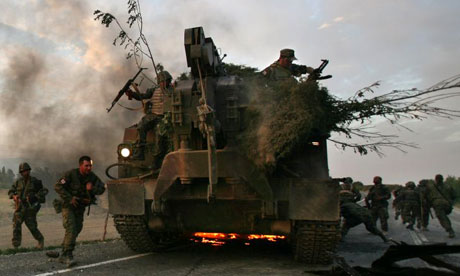 soldiers escape their burning armoured vehicle on the road to Tbilisi
