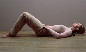 Woman laying on wooden floor