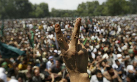 A Kashmiri Muslim shows a victory sign during a march in Srinagar, India