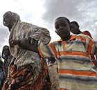 Somali refugees fleeing fighting in their home country walk to a registration centre for a camp in Kenya