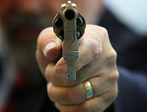 An armed response officer from the Greater Manchester Police poses with a gun at a press conference