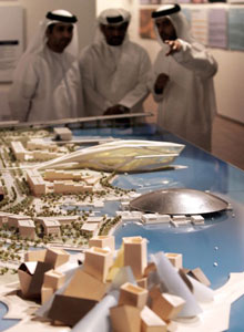 Emirati men discuss scale models of new museums in Abu Dhabi