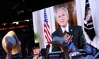Texas delegates react as President Bush speaks via satellite at the Republican National Convention in St. Paul, Minneapolis