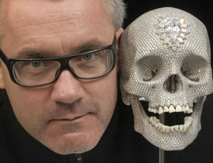 Damien Hirst poses with his diamond encrusted skull, 'For the love of God'