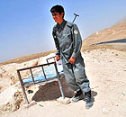 A young Afghan policeman guards the boundary between Wardak and Kabul provinces 