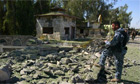 An Iraqi soldier looks at the damage caused by a suicide bomber in Mosul, 2008