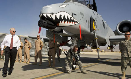US defence secretary Robert Gates greets aircraft crew on a visit to Afghanistan, where, he says, more troops are needed