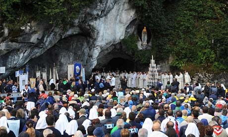 Pilgrims celebrate mass at Lourdes Photograph JeanPierre Muller AFP Getty 