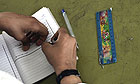 A pupil takes notes at the al-Majida Waseela School in Gaza