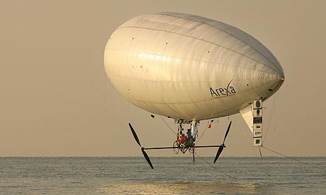 Balloonist Stephane Rousson pedals his airship out over the English Channel