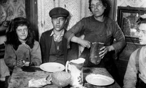 A London family sits down to a meal of bread in 1920