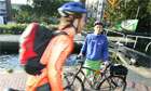 Towpath ranger  Joseph Young watches a cyclist next to Regent's canal