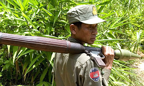 A Cambodian soldier carrying a rocket launcher patrols the border with Thailand